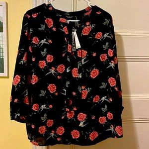 Grace the perfect fit. Flower and black blouse